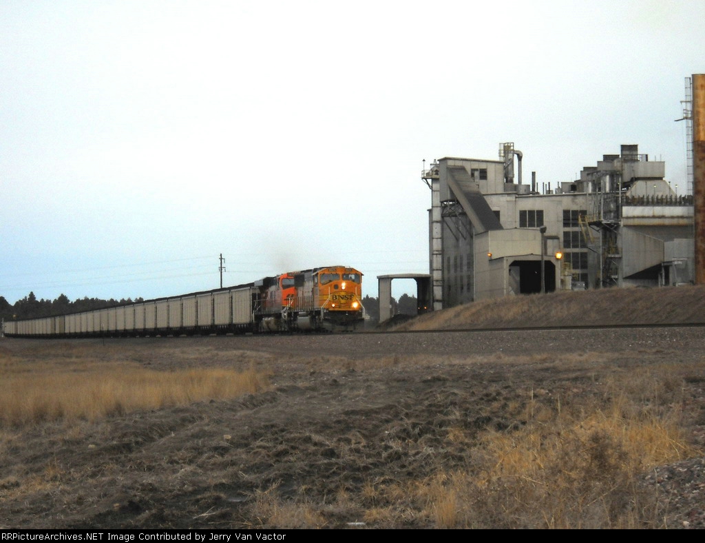 Eastbound coal passes the Osage Power plant which is fueled by coal